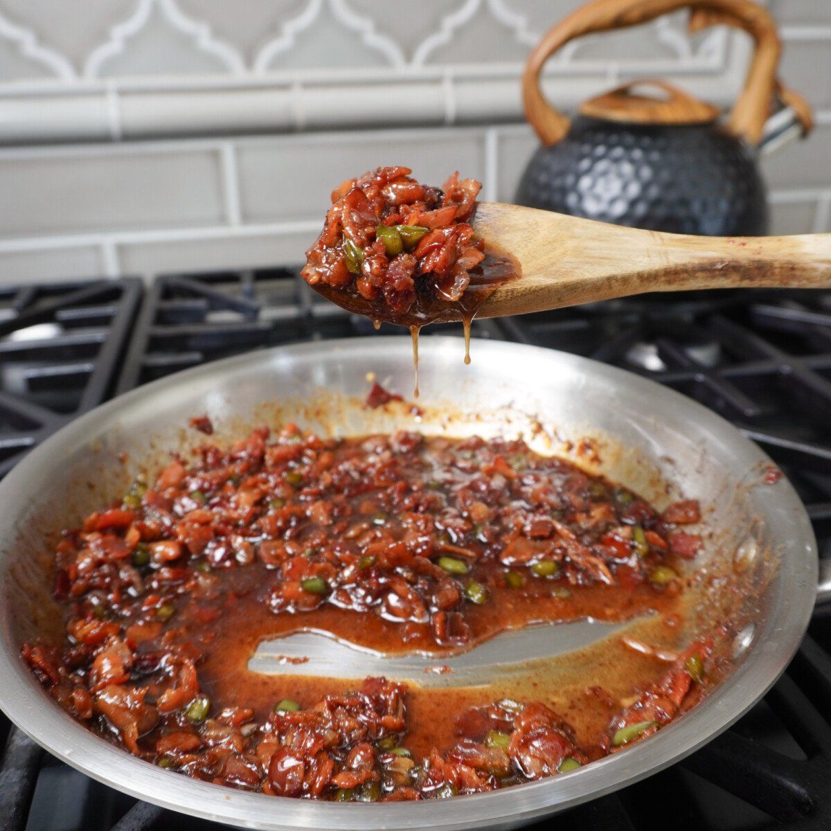 jalapeno bacon jam on a wooden spoon.