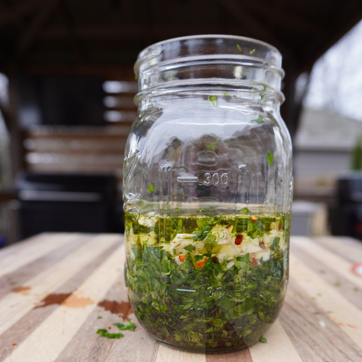 chimichurri ingredients in a mason jar.