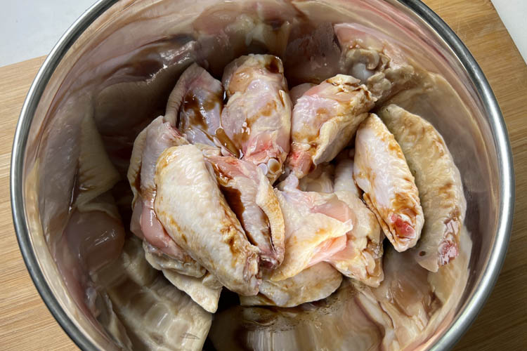 wings with binder in metal bowl