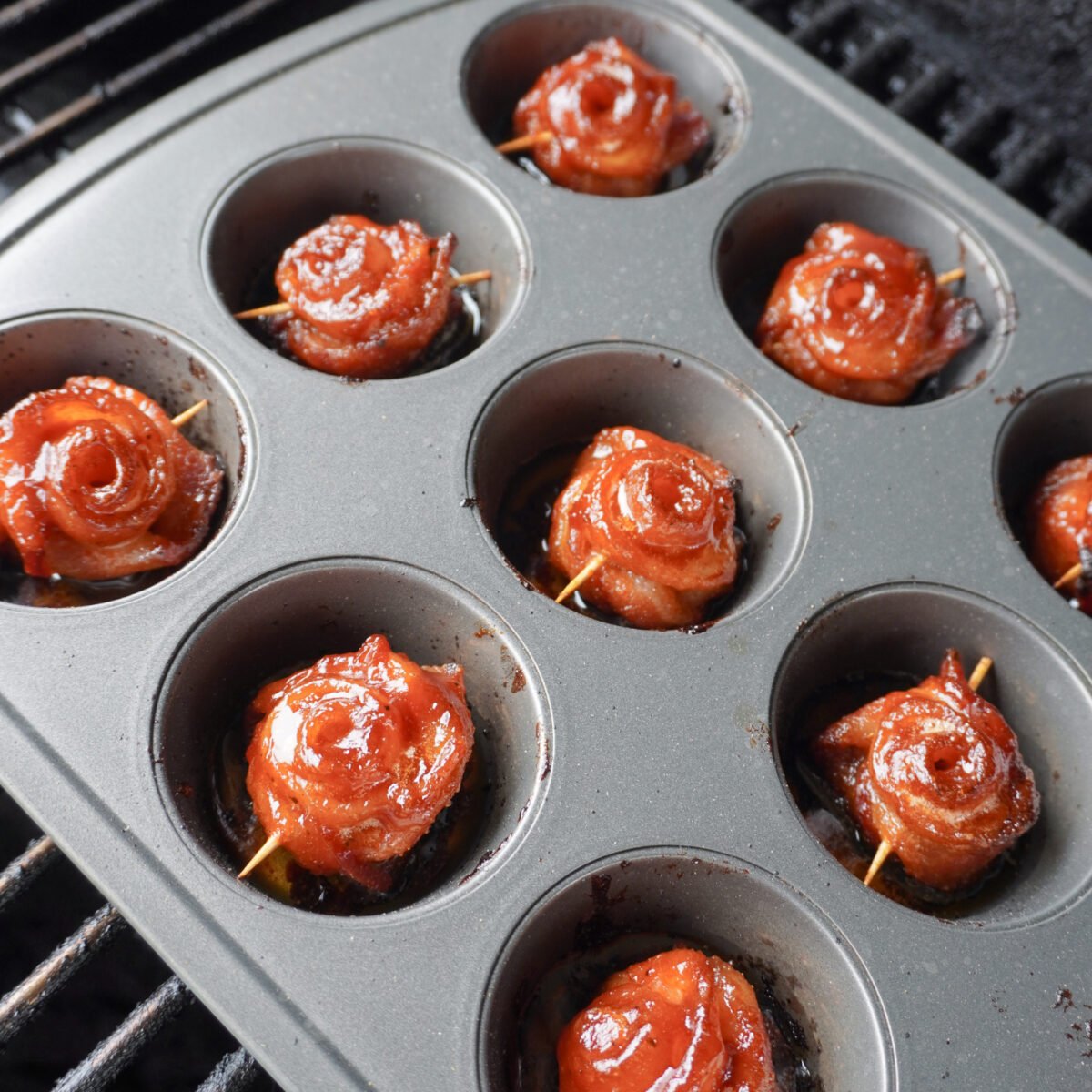 grilled bacon roses on grill in muffin pan.