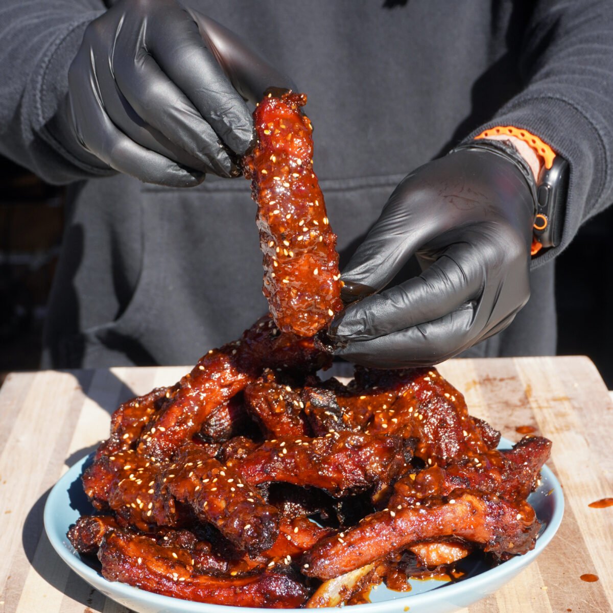 Chili Crunch Party Ribs presented by hand.
