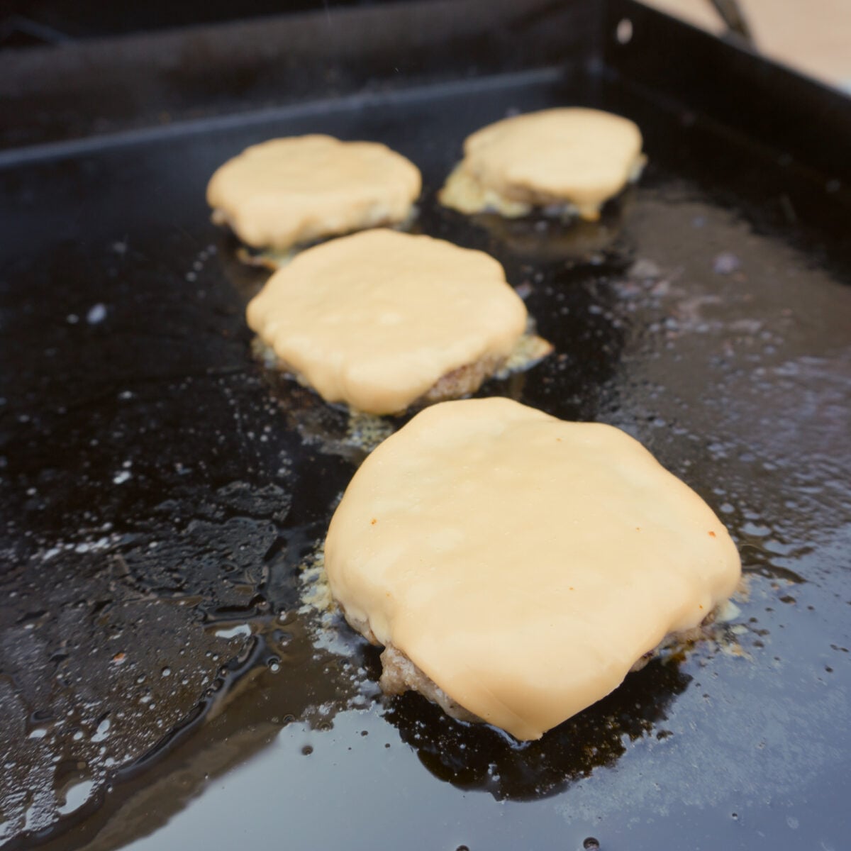 homemade mcgriddle sandwich patties with melted american cheese.