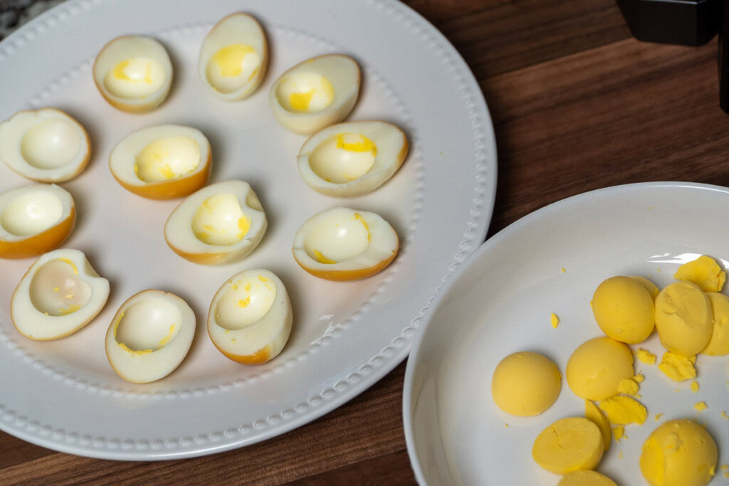 a plate of hard boiled egg yolks and a plate of hard boiled egg whites