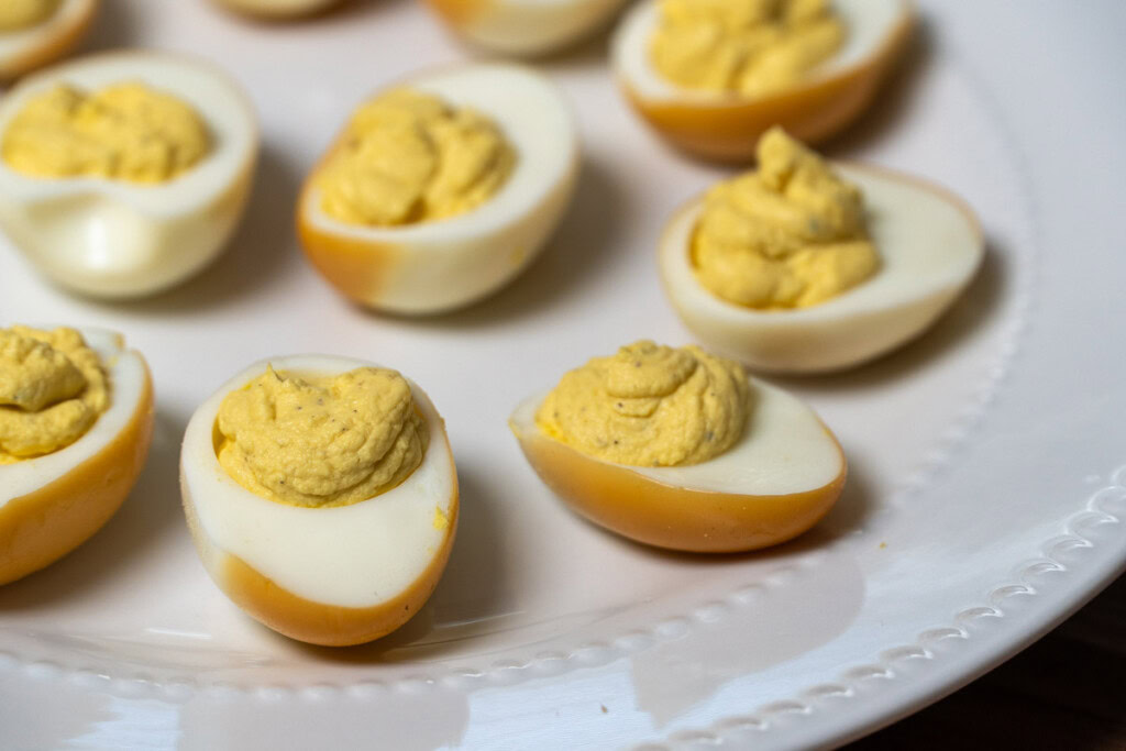 smoked deviled eggs on a white plate