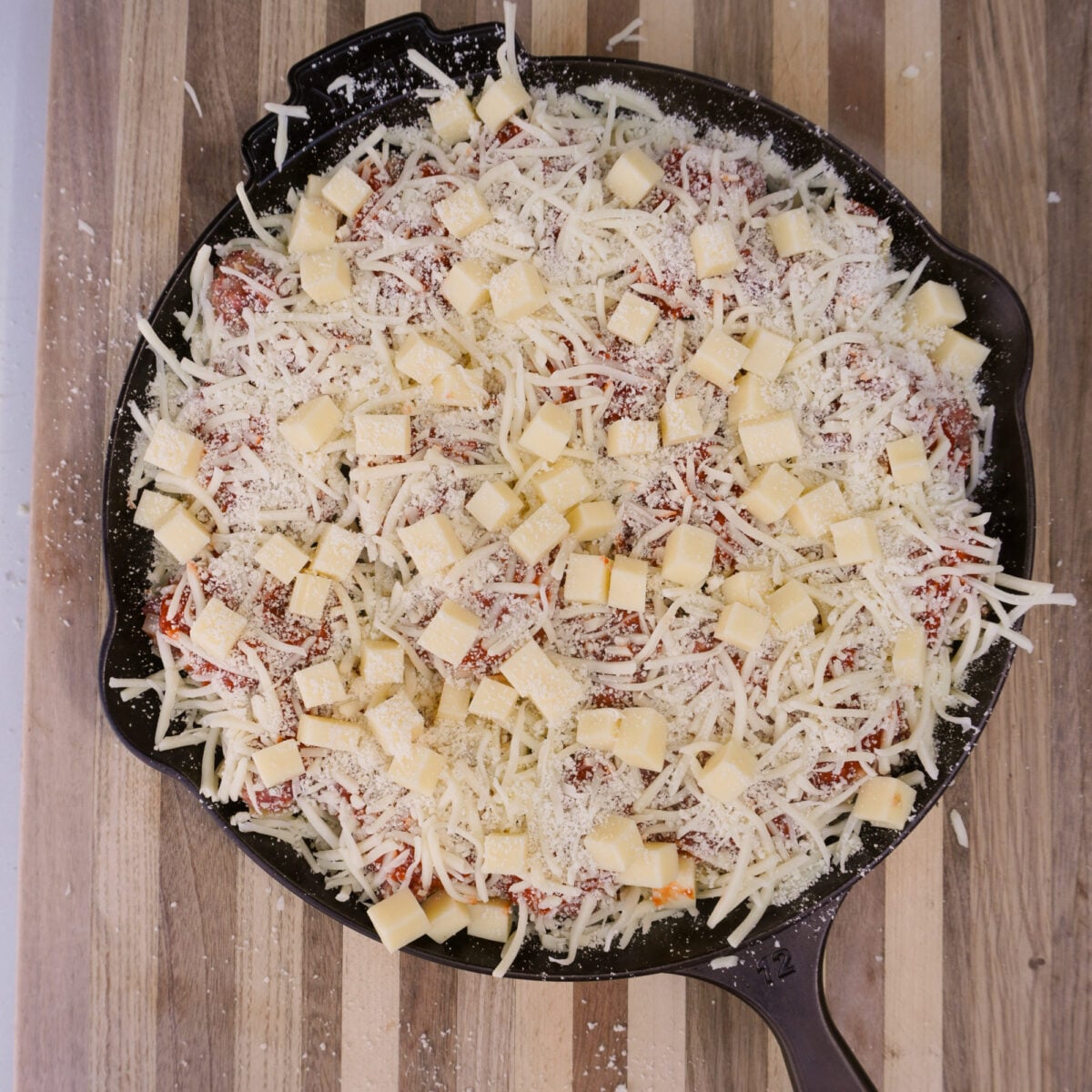 cheese covered cast iron skillet.