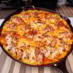 Smoked stuffed shells in a cast iron skillet.