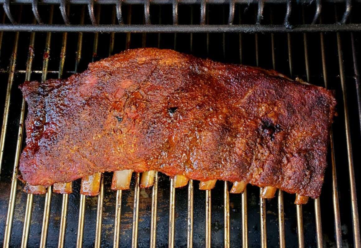 Pellet grill spare ribs wrapped and unwrapped on the grill