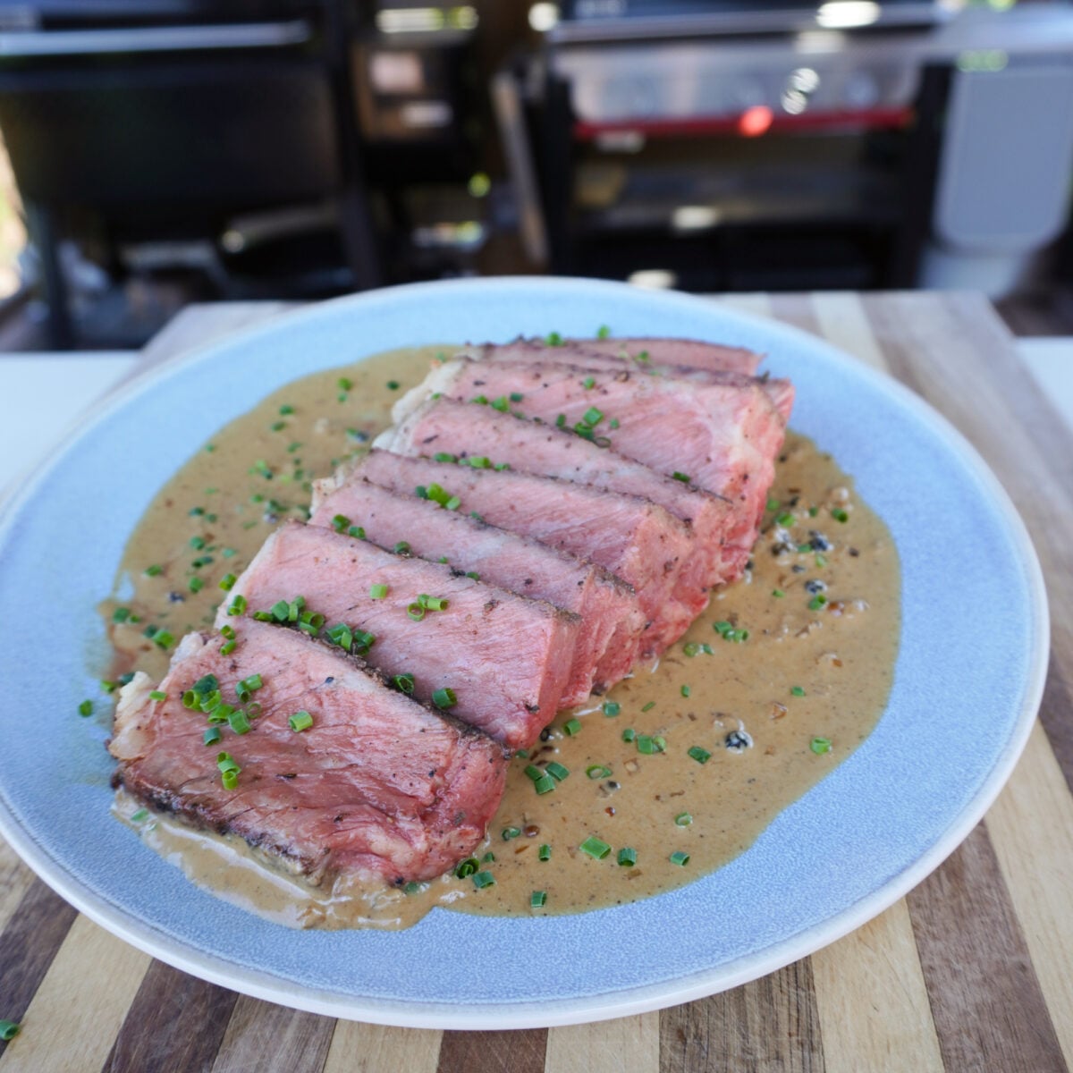 Grilled Porterhouse Steak with a peppercorn sauce plated.