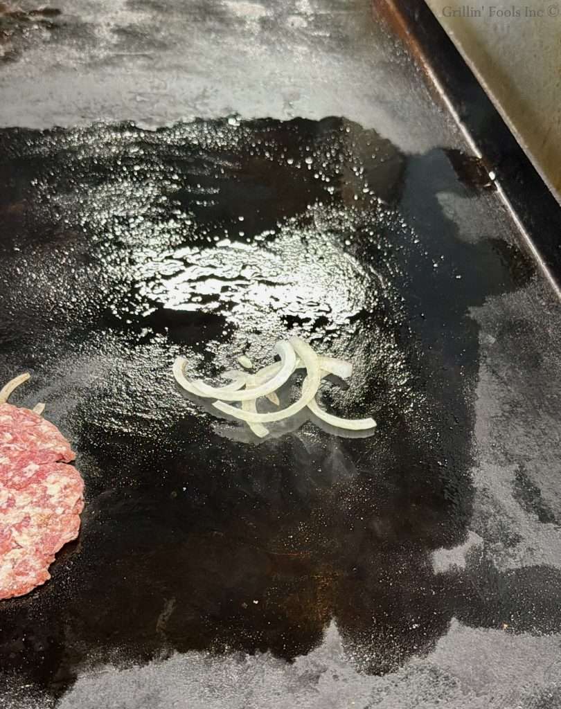 Sliced onion on a flat top grill