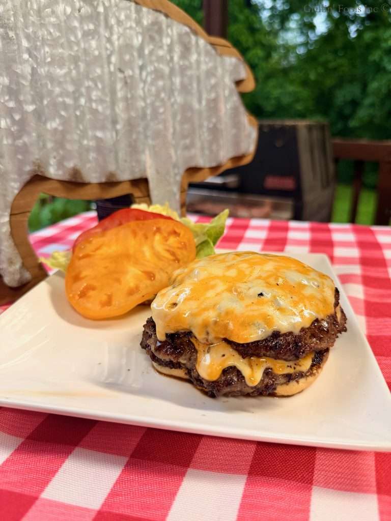 Triple decker, ground pork smash burgers with cheese and tomato and lettuce