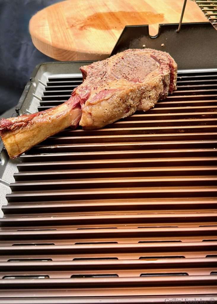 A tomahawk steak, sitting about 120F being seared on a MHP Hybrid sear station because this is how to cook a tomahawk