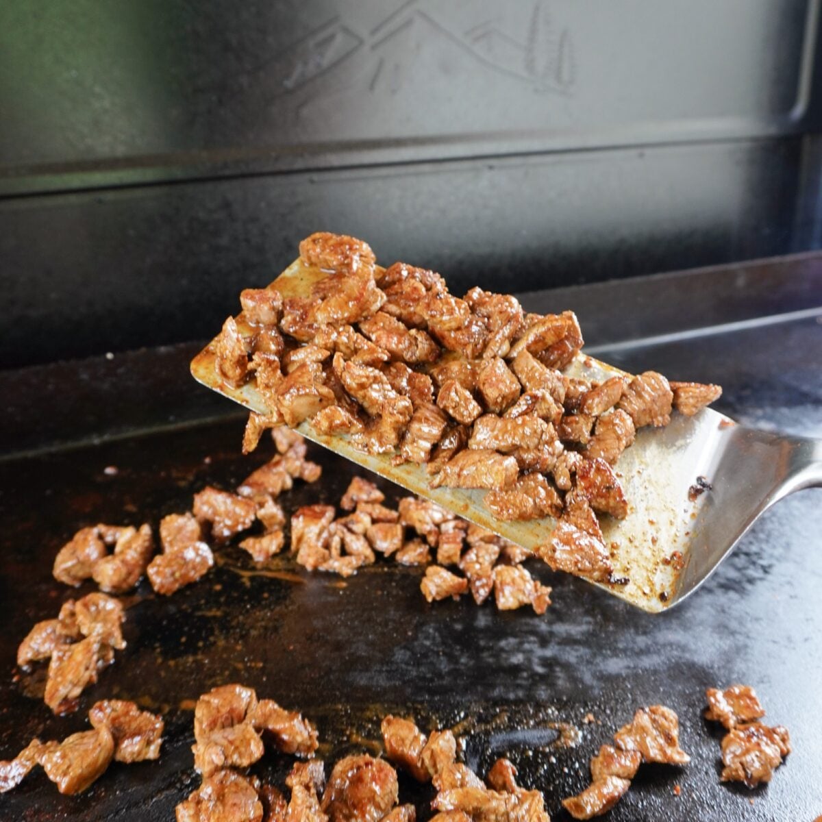 Grilled flank steak cubes on the griddle.