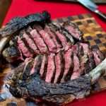 Two medium rare tomahawk steaks, meat removed from the bone and sliced