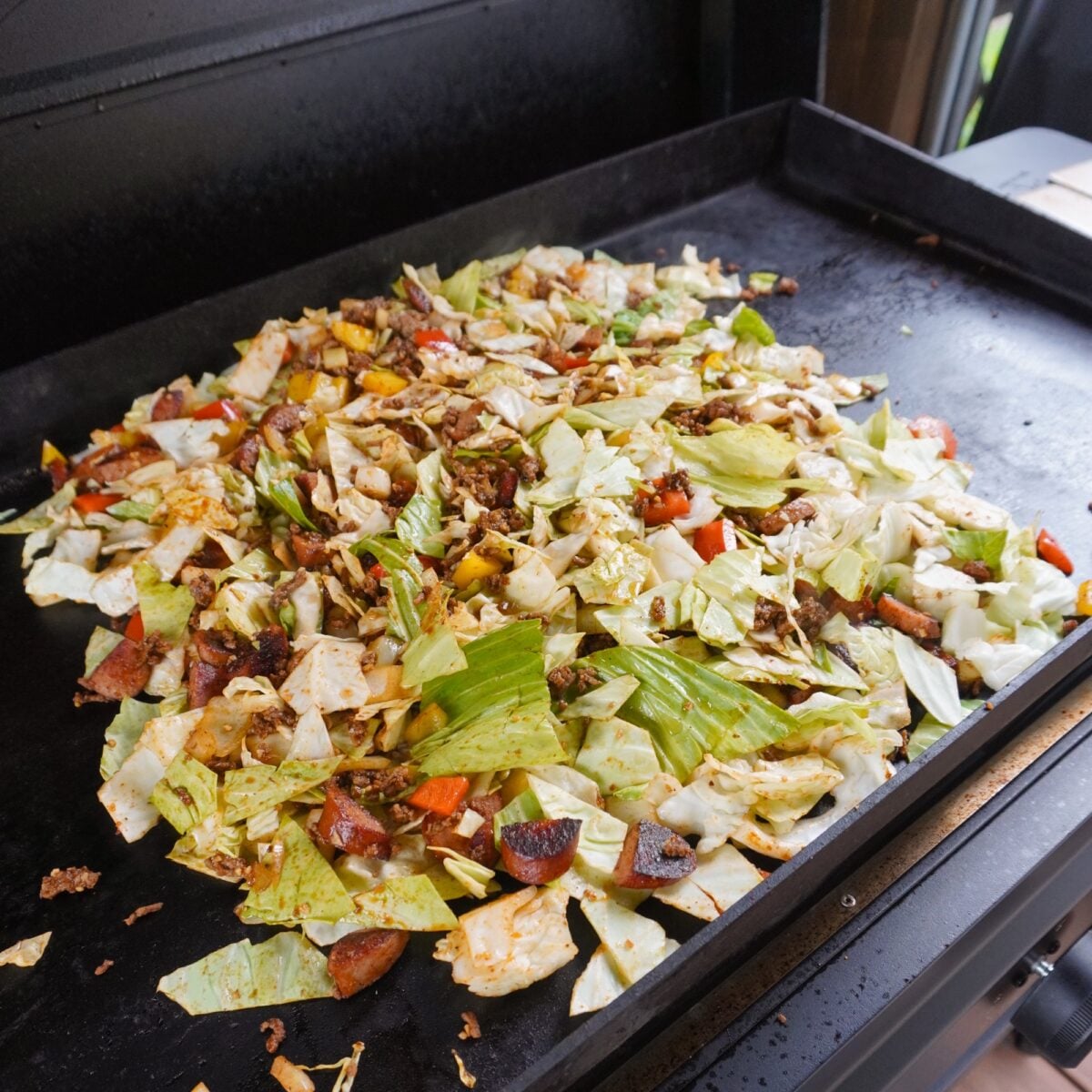 Sauteed veggies mixed in with the protein for the Grilled Dirty Cabbage recipe.