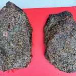 Two smoked beef briskets on a cutting board, both of which have excellent blackened bark and the pic is taken from above