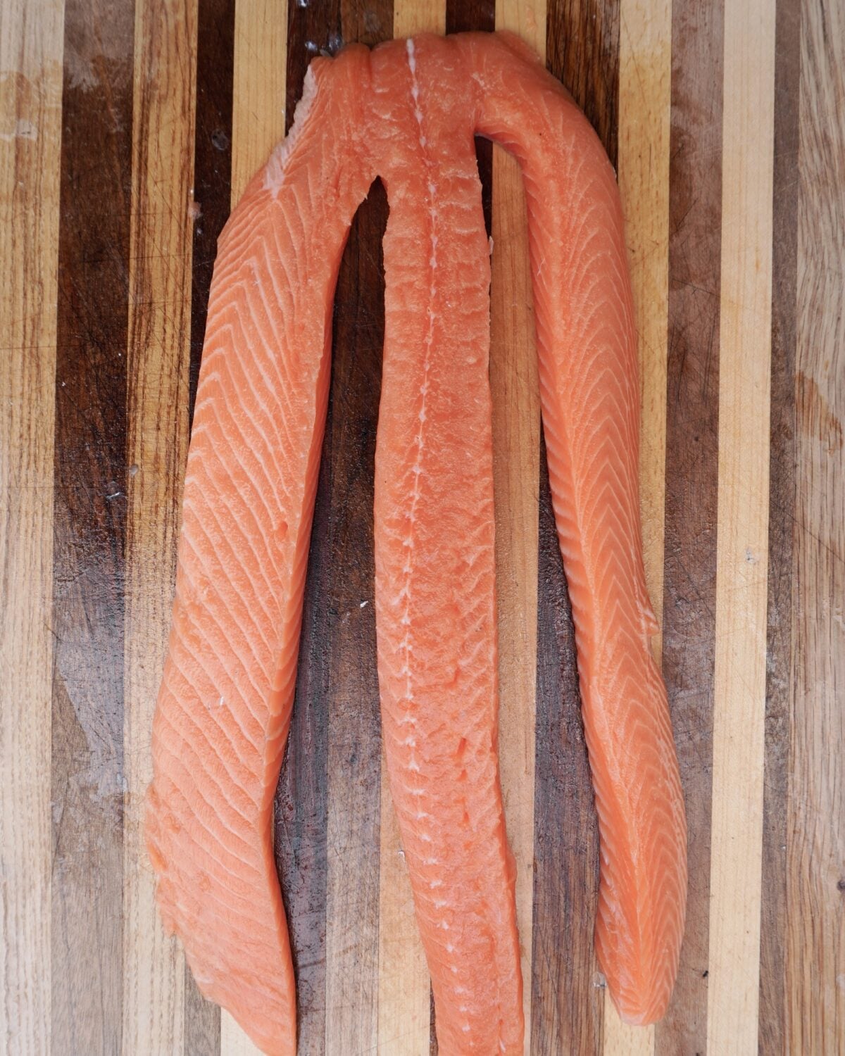 Salmon filet separate into 3 even strips.