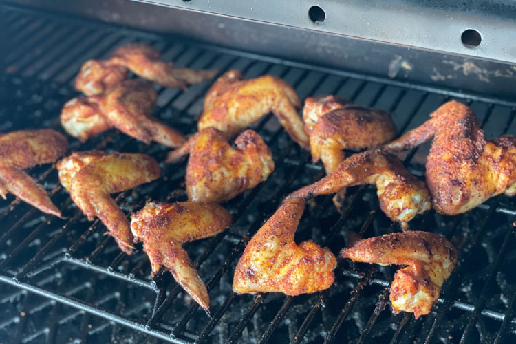 wings on grill in smoker
