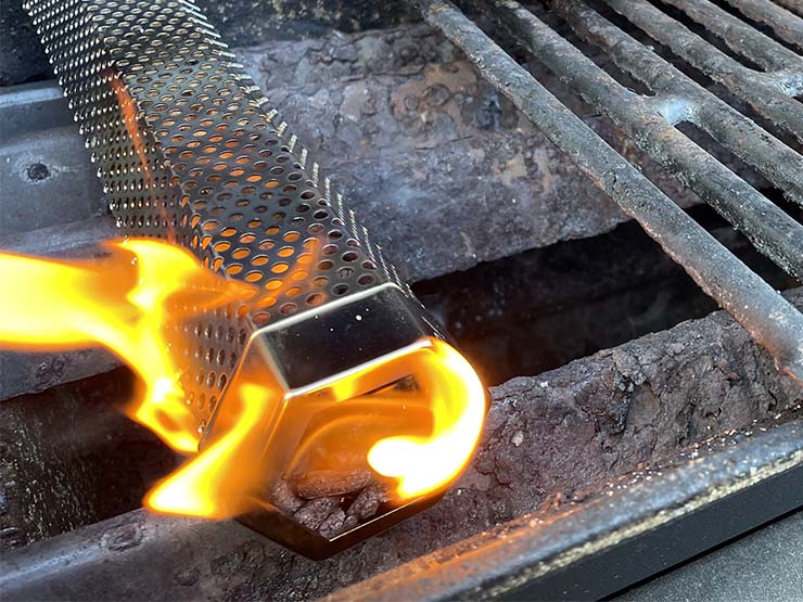 tube smoker with lit pellets inside