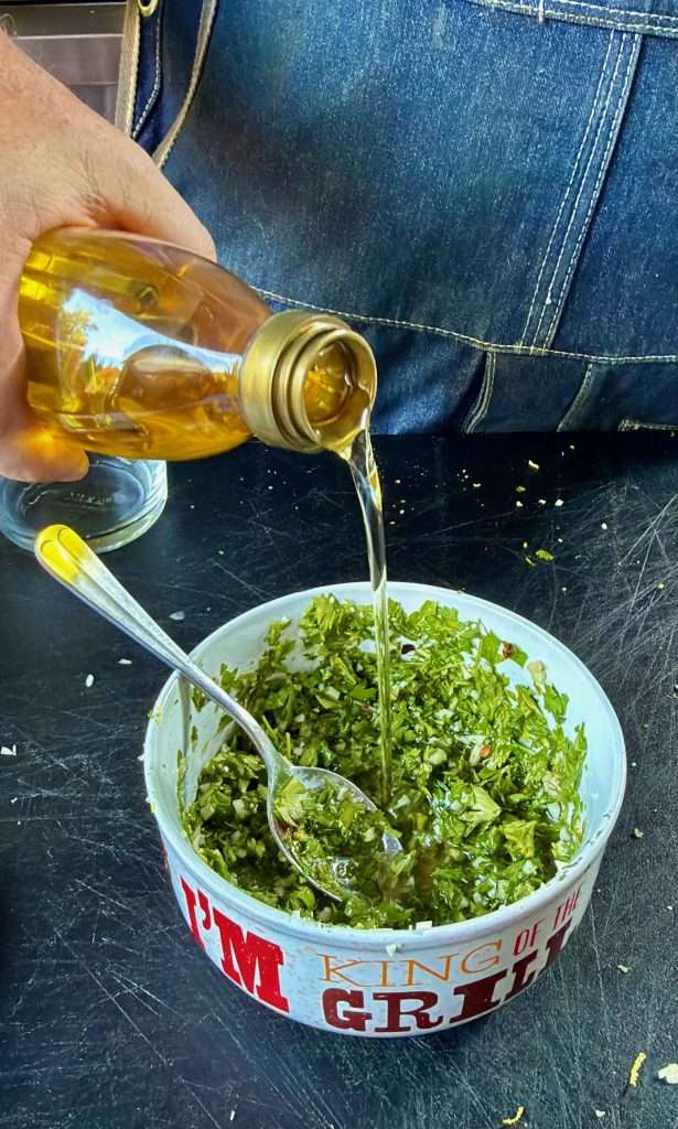 Pouring a little extra oil into my chimichurri