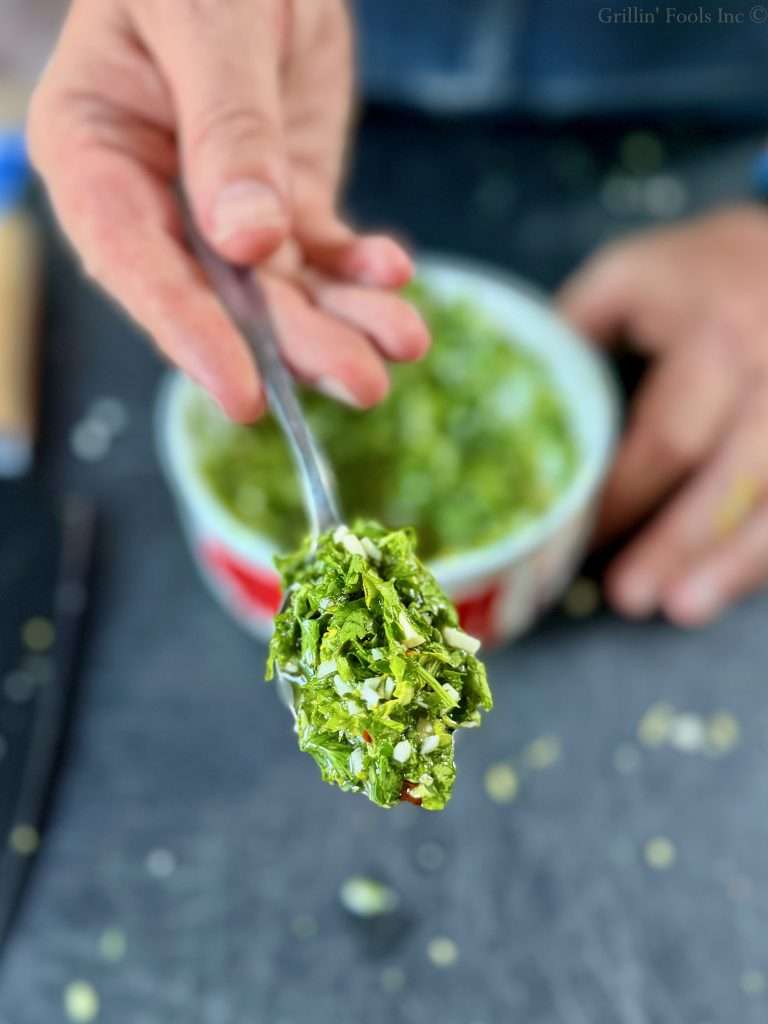 A spoonful of thick and very green chimichurri sauce