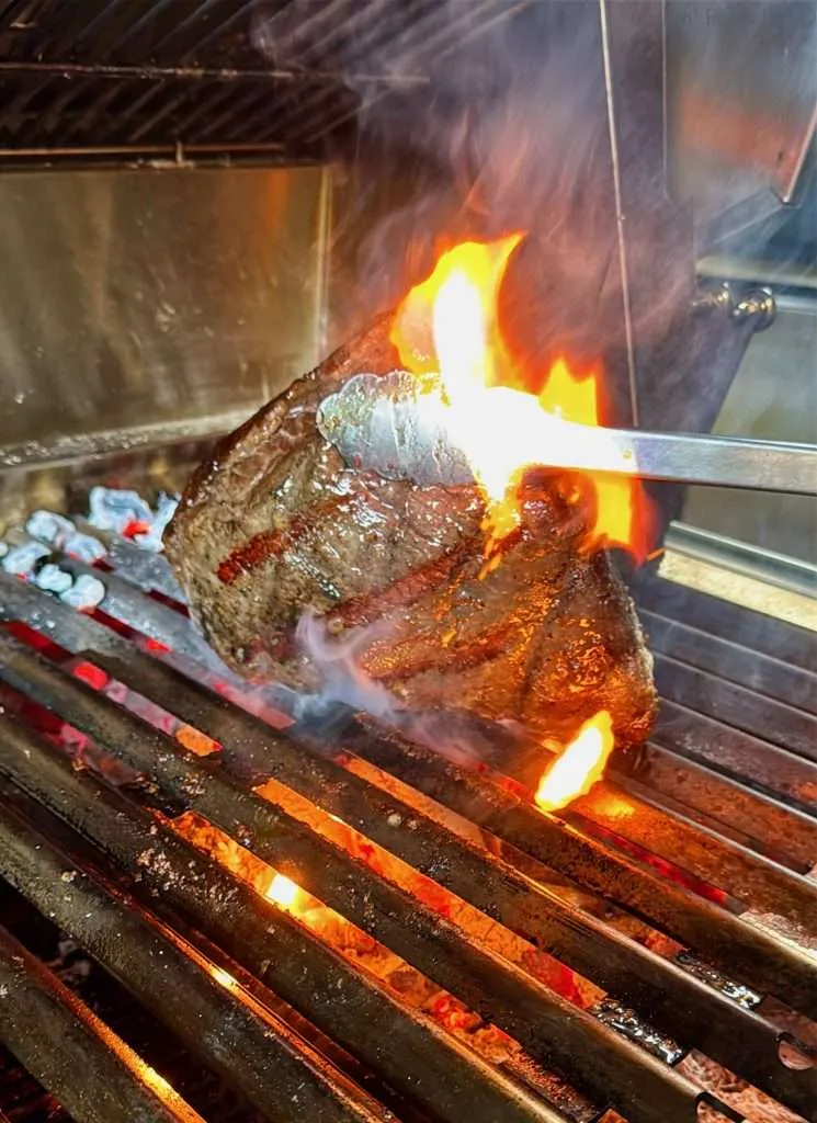 Browned striped of flavor char on the meat side of a picanha roast
