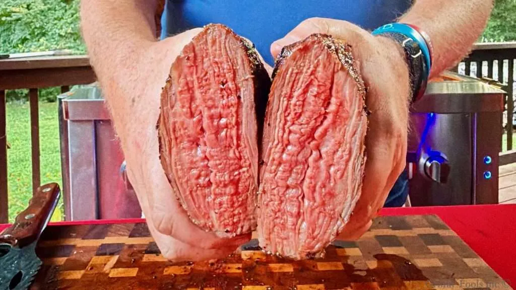 A cross section of grilled tri tip, sliced in half, cooked to a beautiful medium rare