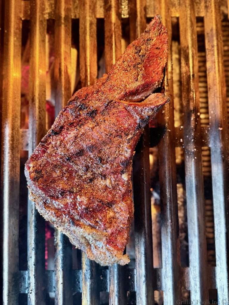 A seared tri tip roast on a hot grill