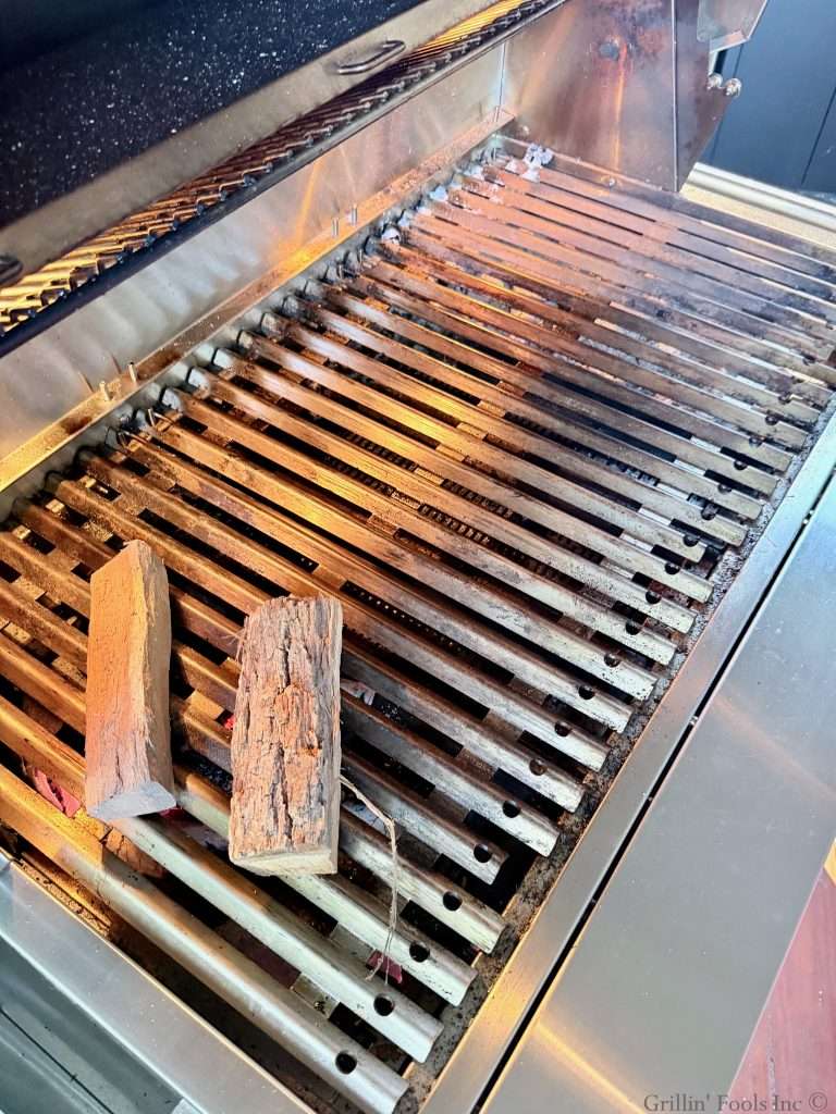 Smoke wood over the top of the hot coals to provide the smoke for the tri tips