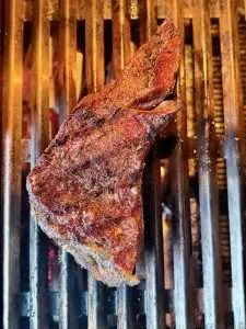 A seared tri tip roast on a hot grill