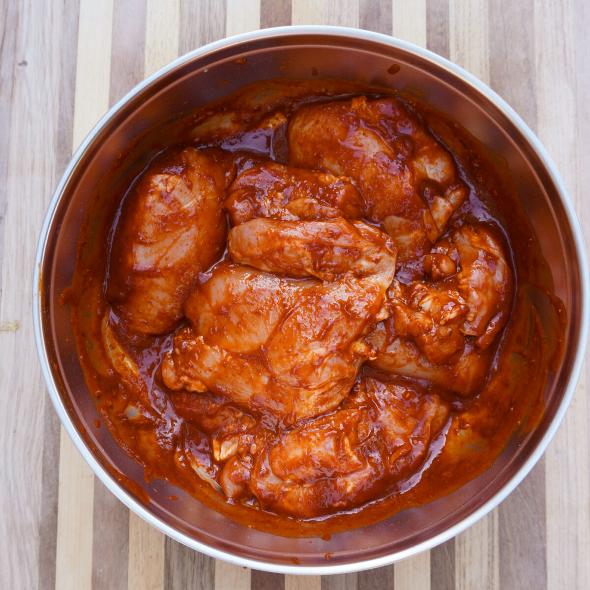 Chipotle marinating chicken in bowl.