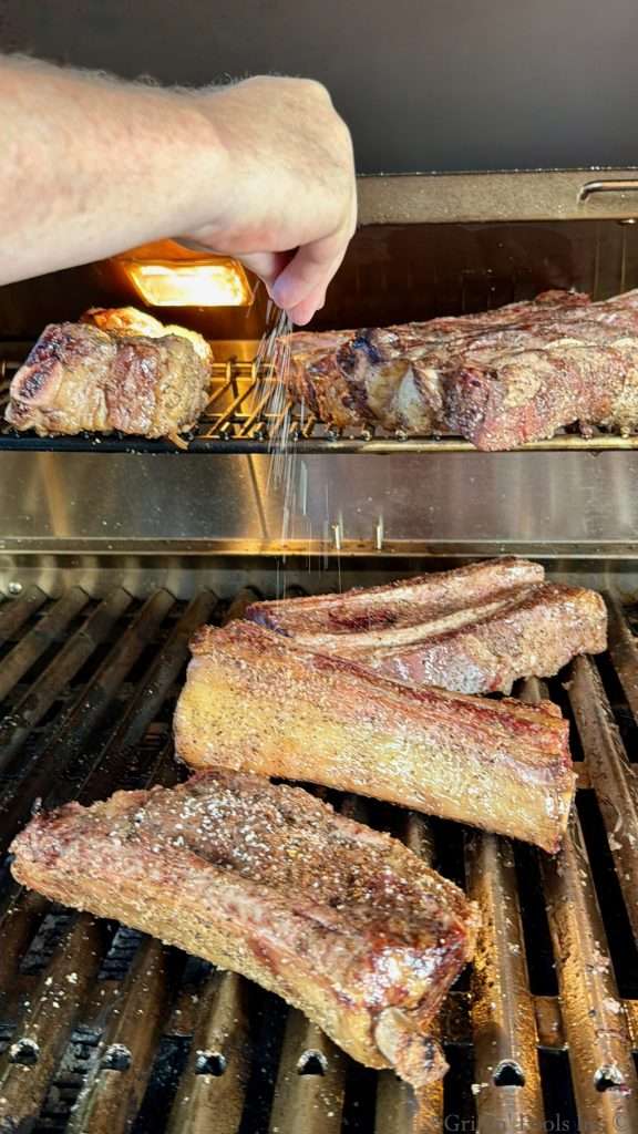 Adding a little bit more seasoning to the beef ribs