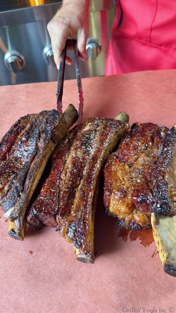 Three beef ribs on peach butcher paper