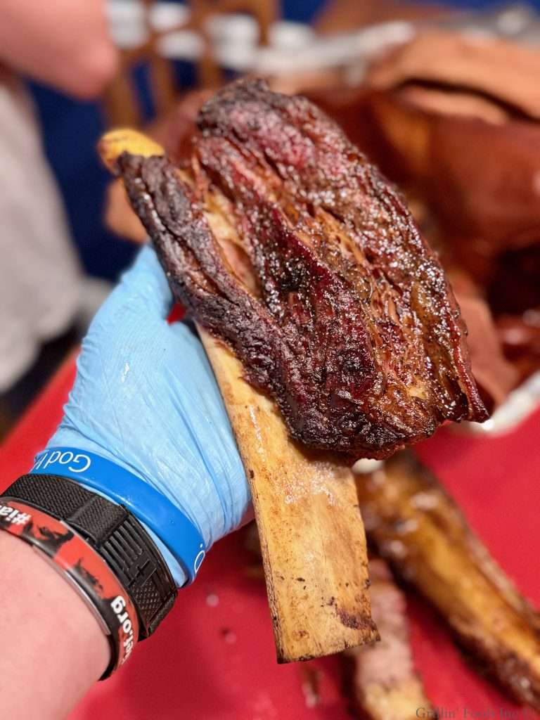 A cooked beef rib with beautiful mahogany bark
