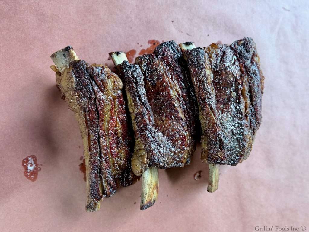 Seasoned beef ribs on a sheet of butcher paper