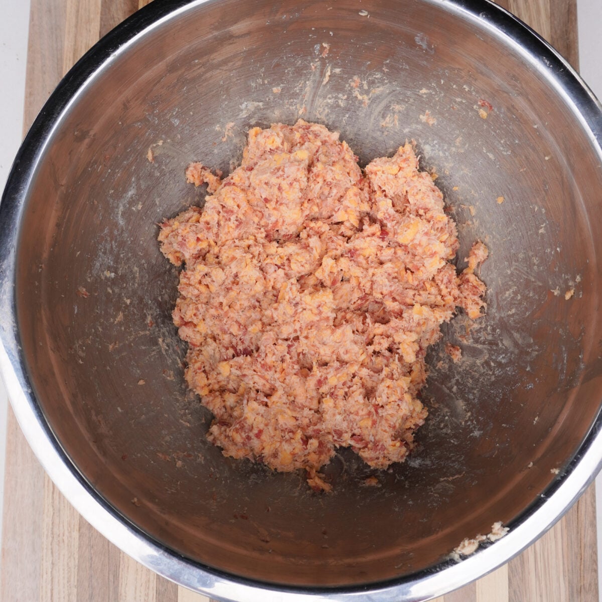 sausage, cheese and biscuit mixture in a large metal bowl.
