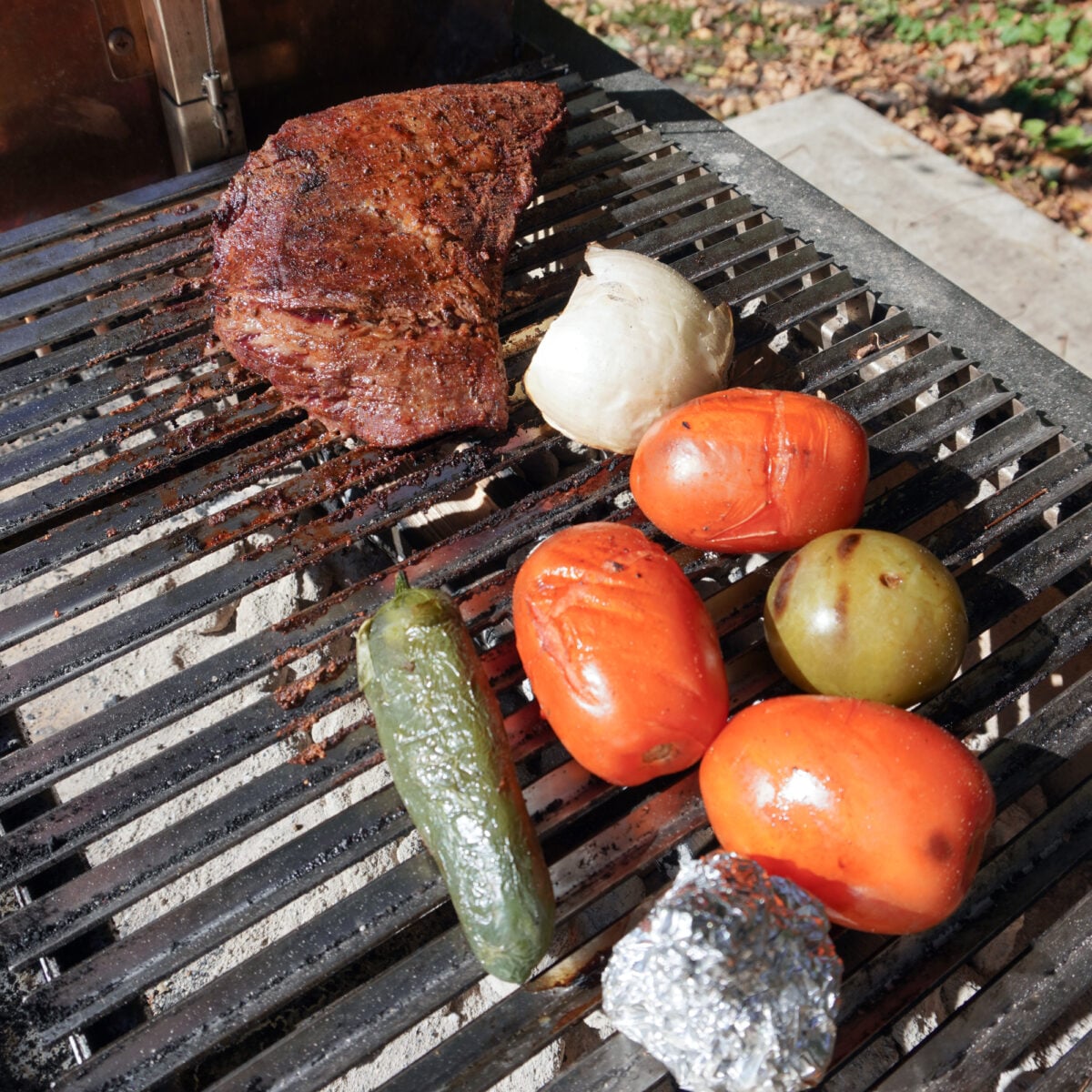 Grilled California style tri tip steak with roasted veggies on a Santa Maria style grill.