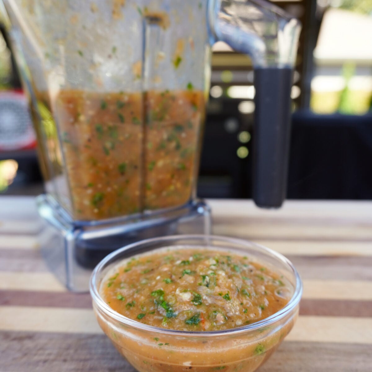 Easy homemade salsa in blender and clear bowl.