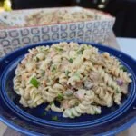 Caramelized Onion and Chicken Pasta dish on a blue plate.