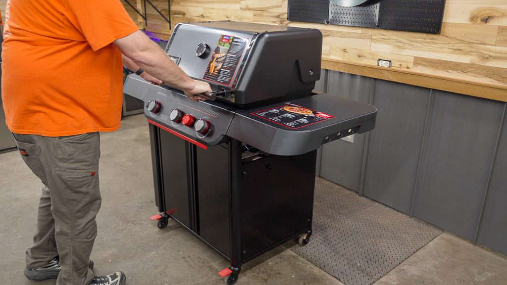 Factory stickers on the lid and side shelf of the Weber Genesis E-330 Stealth