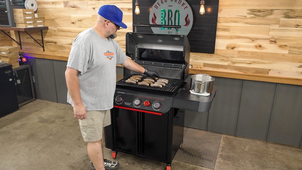 Grilling brats next to a pot of braised brats on the Weber Genesis E-330 Stealth