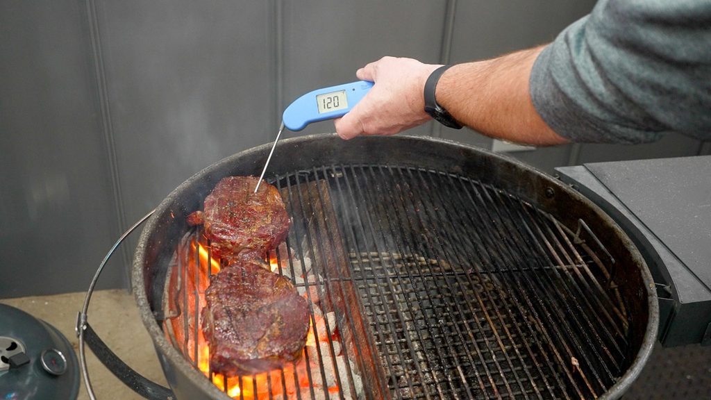 Checking steaks reading 120F on the Slow 'N Sear kettle