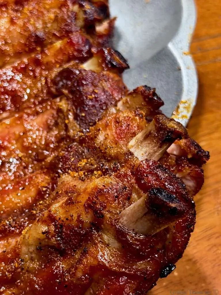 A close up of the protruding bones from the baby back ribs