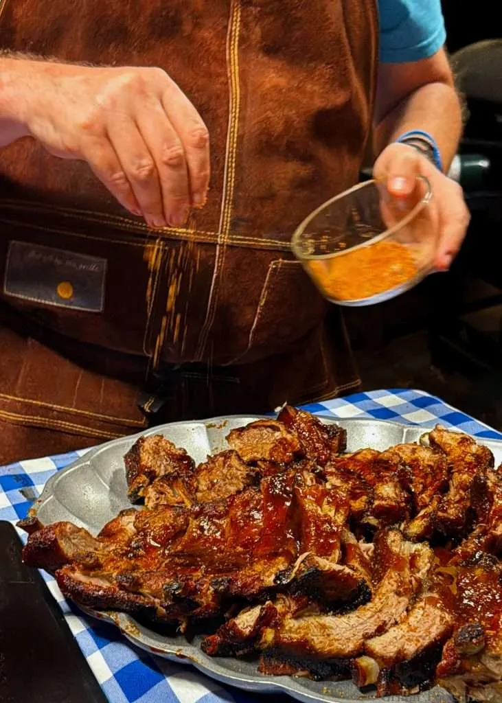 Seasoning the ribs with a little extra BBQ rub